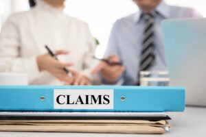 Claims document folder in meeting room, Contractors talking with board manager about the importance of claims management for contractors.