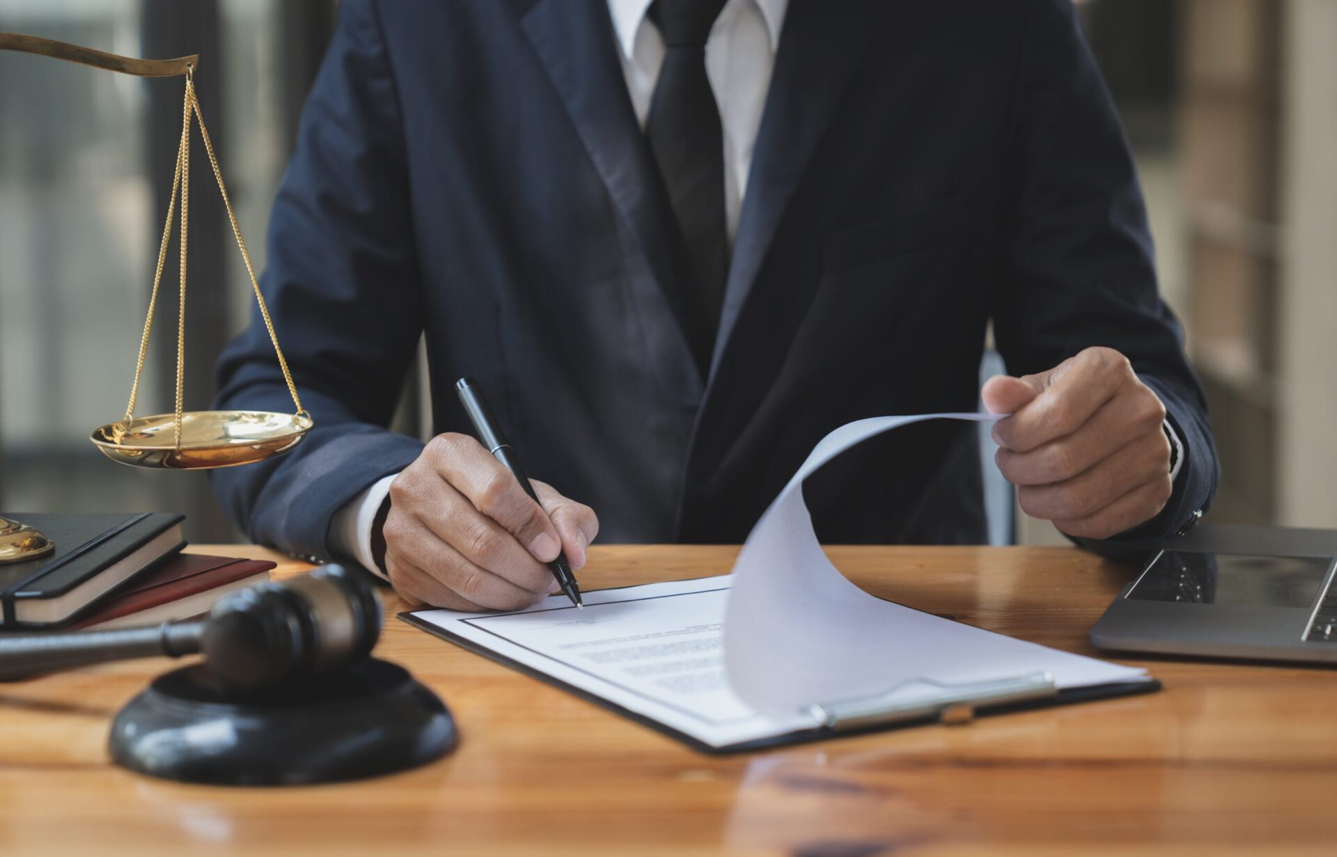 Lawyer sitting at the office and singing some papers.